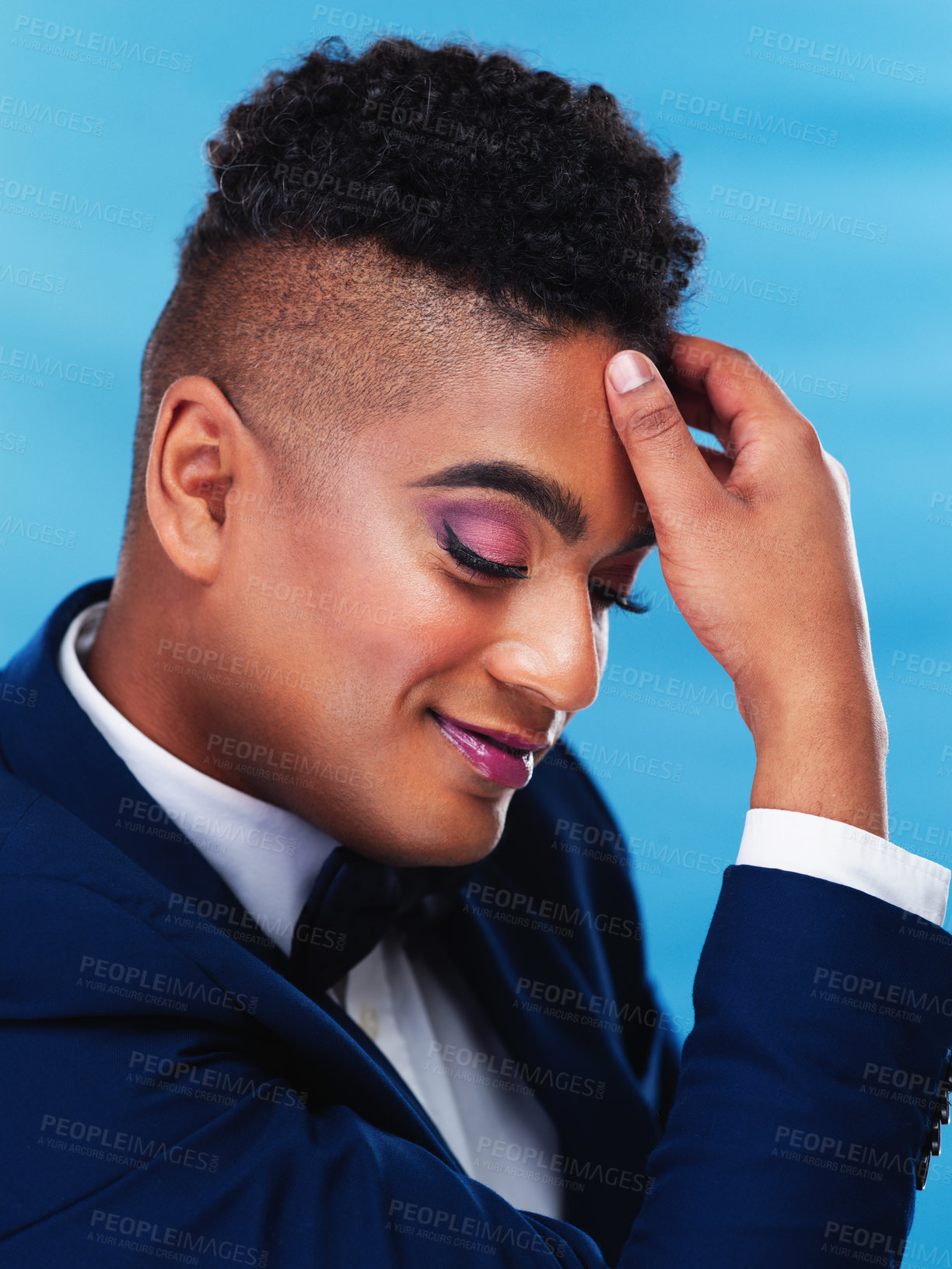 Buy stock photo Cropped shot of a gender fluid young businessman posing against a blue background