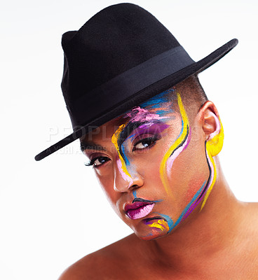 Buy stock photo Portrait of a gender fluid young man wearing face paint and a hat posing against a white background