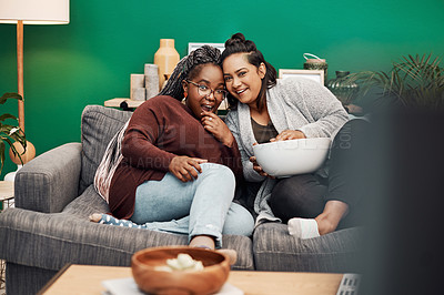 Buy stock photo Girl friends, shocking movie and home living room laughing on a couch with a happy smile. Tv, relax and women together in a lounge with a female friend looking at a television in house with popcorn