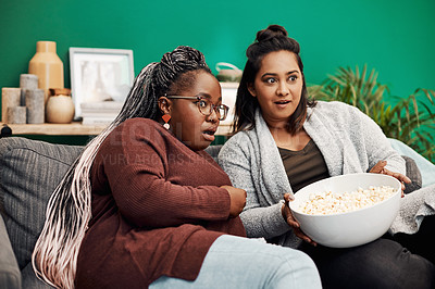 Buy stock photo Girl friends, scary movie and home living room surprised on a couch with fear and shock. Series, tv and women together in a lounge with a female friend looking at a television in house with popcorn