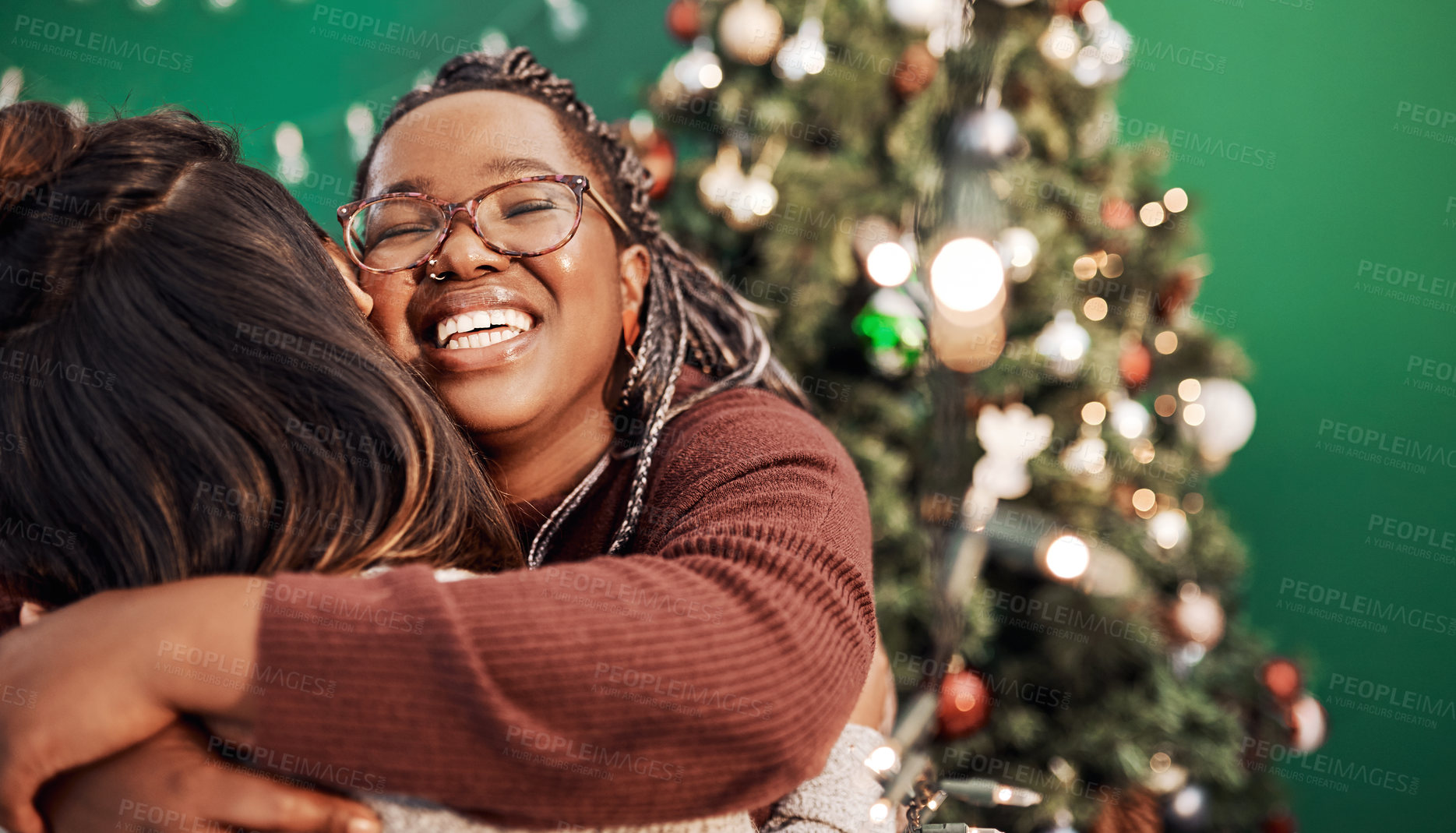 Buy stock photo Friends, hug and Christmas tree for festive, holiday and celebration as happy woman in home. Female people, together and bonding with embrace, excited and solidarity for relationship in December