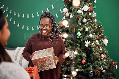 Buy stock photo Women, gifting and Christmas tree for festive, holiday and celebration as happy friends in home. Female people, together and presents with decor, excited and bonding for relationship in December