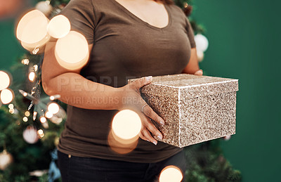Buy stock photo Cropped shot of an unrecognisable women holding a gift box at home on Christmas