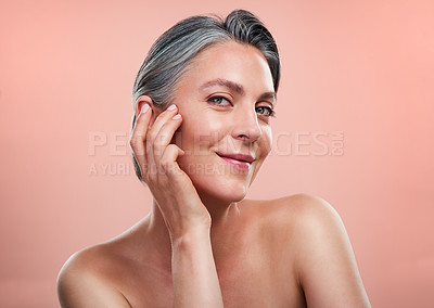 Buy stock photo Portrait, skincare and mature happy woman with anti aging in studio for cosmetology, dermatology or natural glow on pink background. Wellness, hands and model for facial, spa treatment or cosmetics