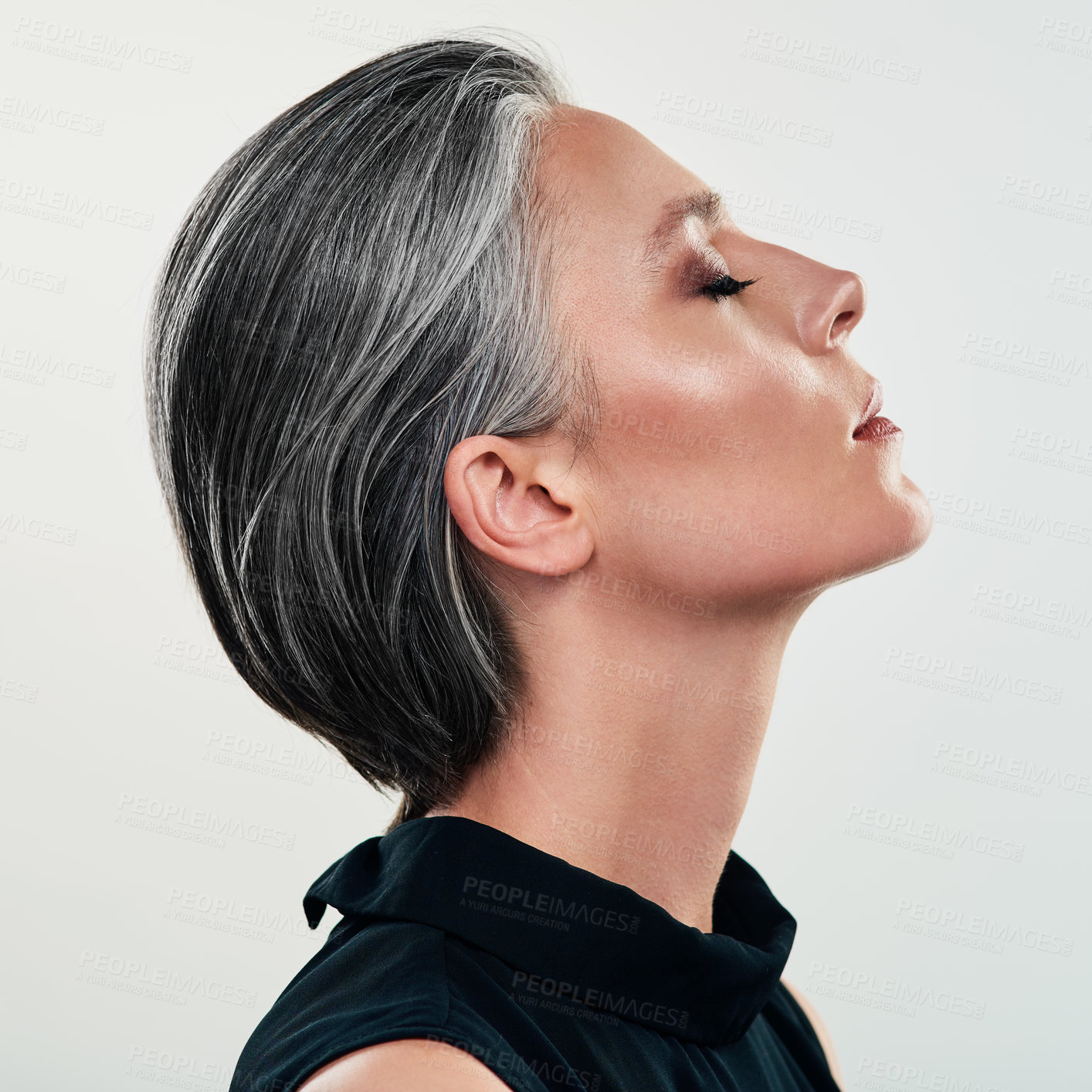 Buy stock photo Studio shot of a beautiful mature woman posing against a grey background