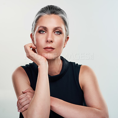 Buy stock photo Studio portrait of a beautiful mature woman posing against a grey background .