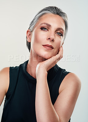 Buy stock photo Studio portrait of a beautiful mature woman posing against a grey background