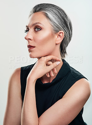 Buy stock photo Studio shot of a beautiful mature woman posing against a grey background