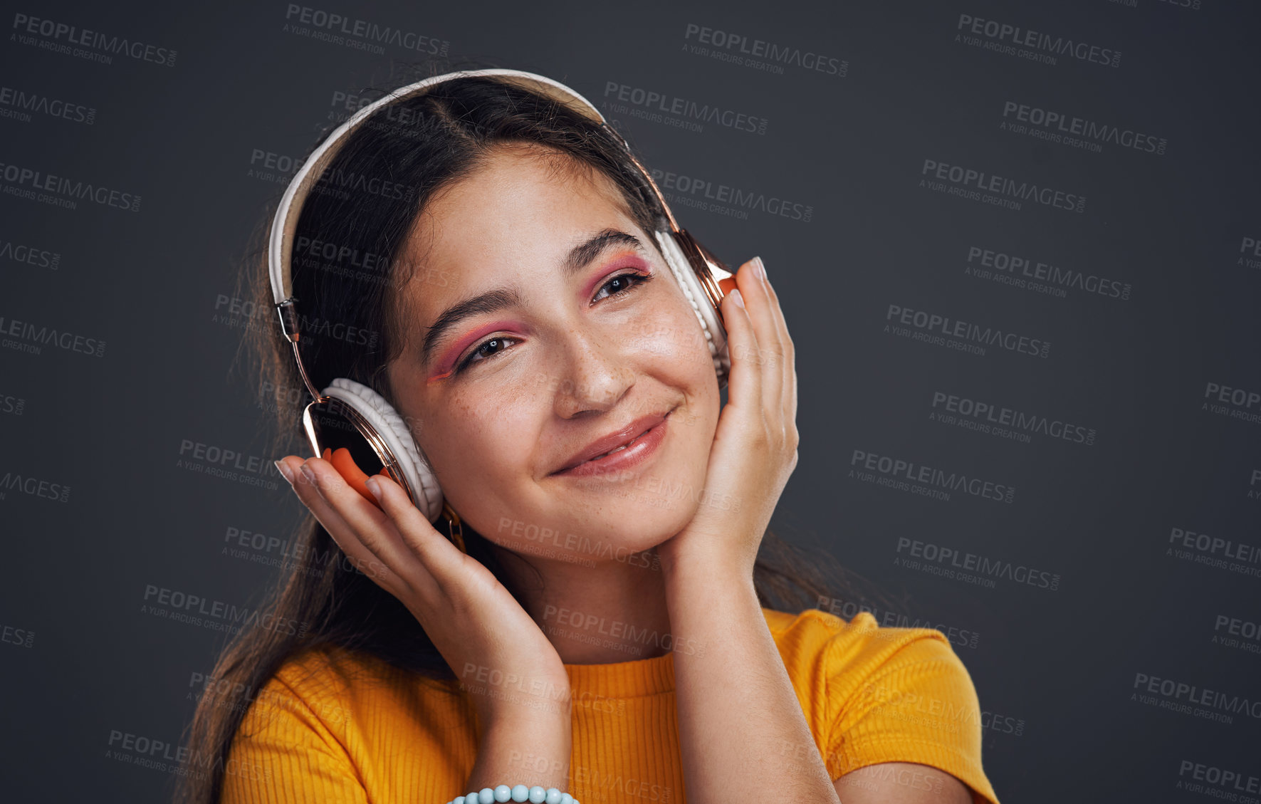 Buy stock photo Girl, headphones and music in studio for peace, smile and streaming online on gray background. Female person, mockup space and playlist for audio connection, listening and subscription for podcast