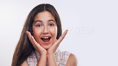 Buy stock photo Cropped portrait of an attractive teenage girl standing alone against a white studio background with her hands to her face