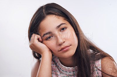 Buy stock photo Cropped portrait of an attractive teenager girl feeling bored while standing alone against a white studio background