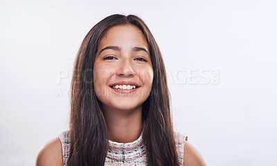 Buy stock photo Cropped portrait of an attractive teenage girl standing alone against a white background in the studio