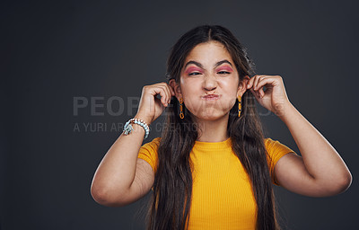 Buy stock photo Comedy, squint and girl in studio for funny joke with humour and crazy pose for goofy emoji with mockup space. Female teenager, comic meme and touch ears with smile for happiness by dark background