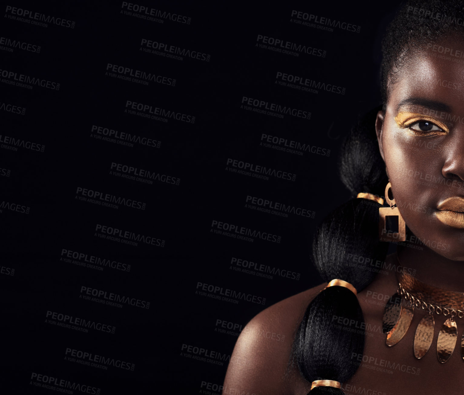 Buy stock photo Half, portrait and black woman in studio with gold, luxury and makeup on black background. Glitter, face and African female model with wealth, glow and jewellery, elegance and posing royal aesthetic