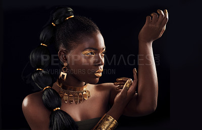 Buy stock photo Studio shot of a beautiful young woman wearing make up and jewellery against a black background