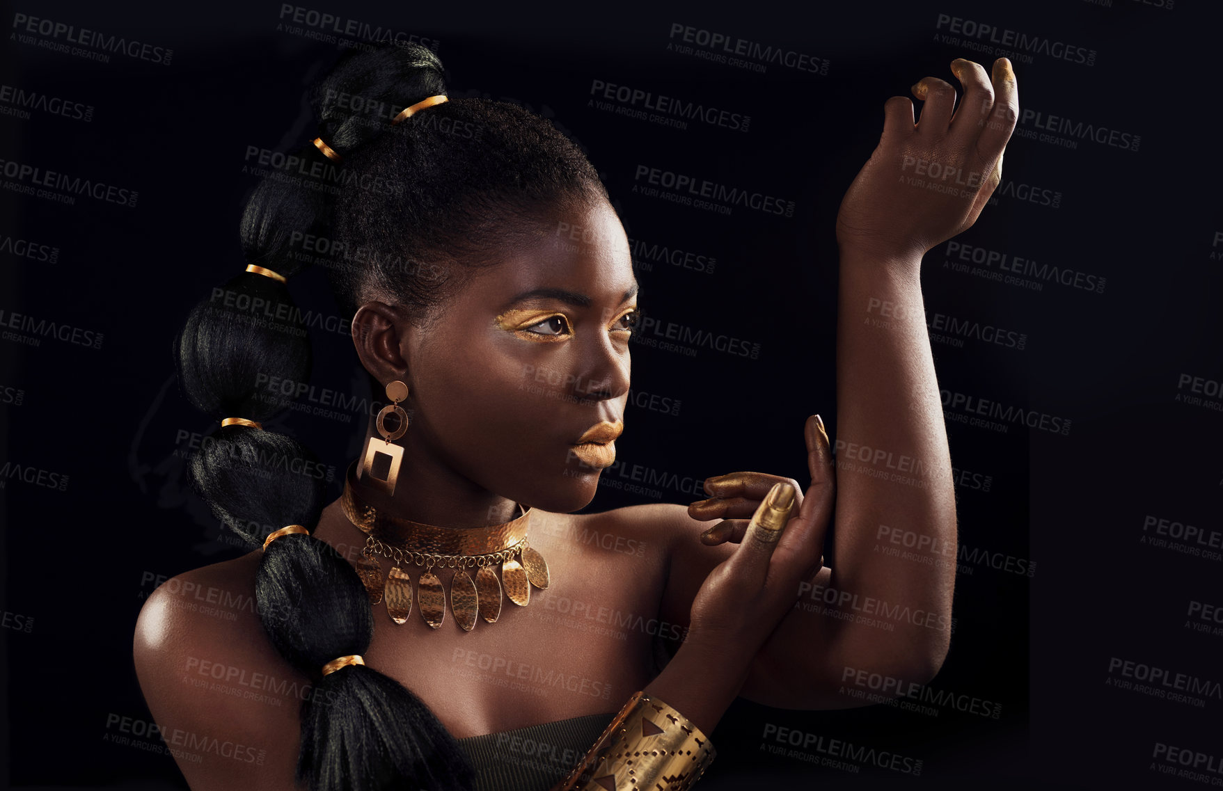 Buy stock photo Studio shot of a beautiful young woman wearing make up and jewellery against a black background