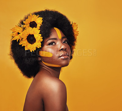 Buy stock photo Makeup, sunflower and african woman with afro in studio for beauty, creative or nature. Natural, cosmetics and floral with face model isolated on yellow backdrop for art, growth and hair