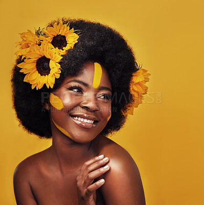 Buy stock photo Black person, beauty and sunflower with skincare in studio for natural glow, cosmetics or soft skin. Woman, plant and confident with smile for organic, dermatology and vitamin e on yellow background