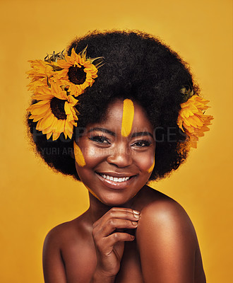 Buy stock photo Black person, portrait and sunflower with skincare in studio for organic cosmetics, treatment or glow. Woman, smile and confident with plant for natural, dermatology or vitamin e on yellow background