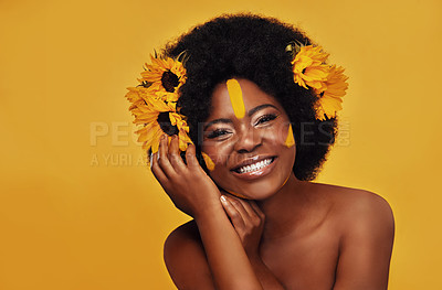Buy stock photo Natural, hair and sunflower with african woman in studio for beauty, creative or spring. Makeup, cosmetics and floral with face portrait of model on yellow background for art, self love or glow