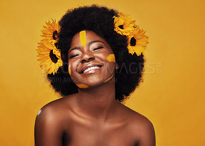 Buy stock photo Black woman, sunflower and paint in studio with makeup for beauty with creative, confidence and spring. Cosmetics, yellow background and self love with natural for floral face with smile for skincare
