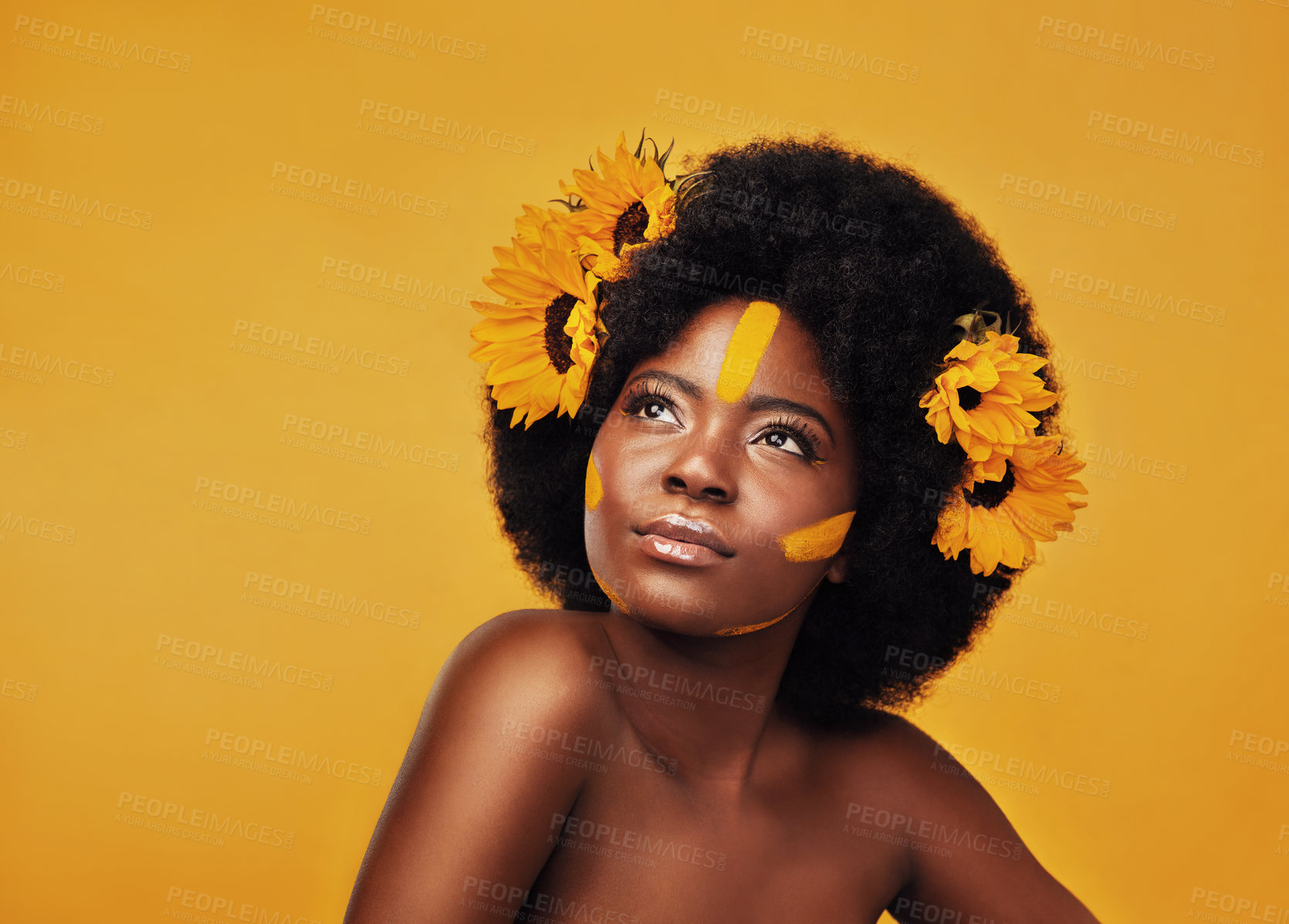 Buy stock photo Woman, studio and thinking with focus and sunflowers for idea, planning or vision with afro. African female and thought on mustard backdrop with makeup, natural beauty or skincare with sustainability