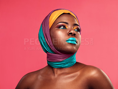 Buy stock photo Studio shot of a beautiful young woman wearing a head wrap and make up against a pink background