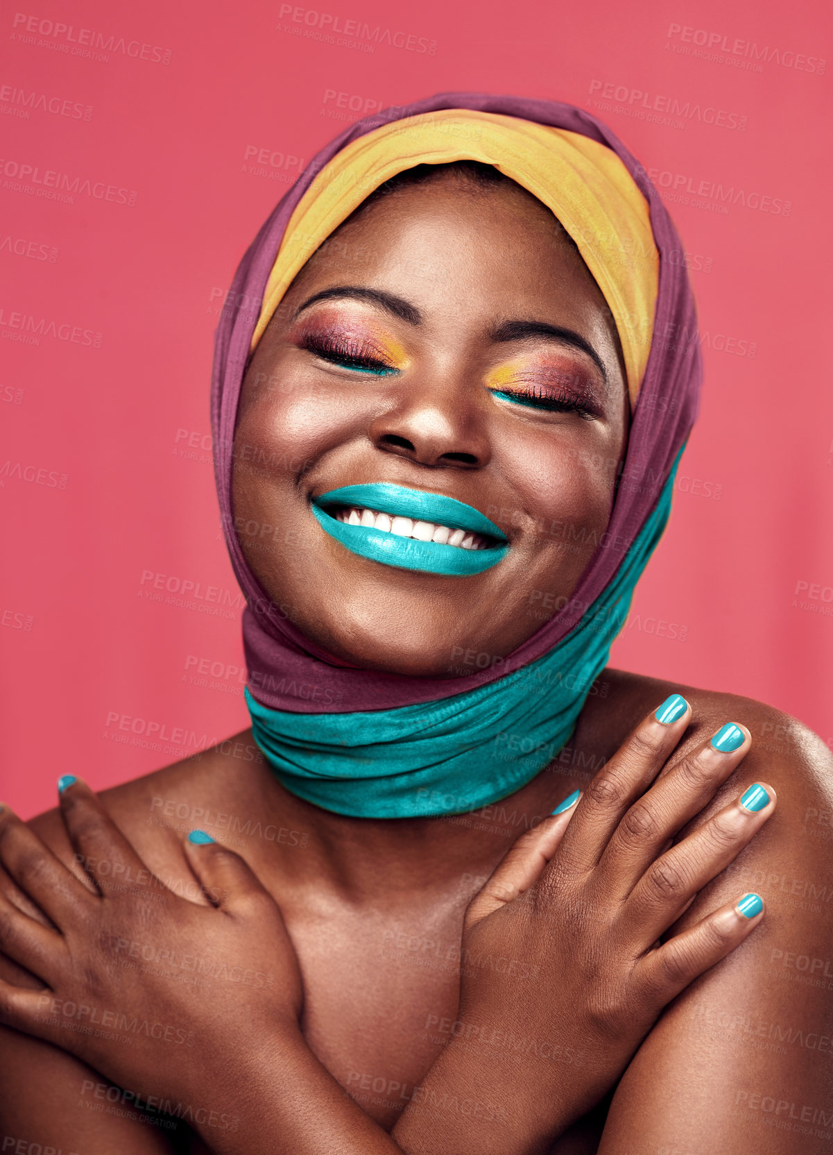 Buy stock photo Studio shot of a beautiful young woman smiling while wearing a head wrap and make up against a pink background