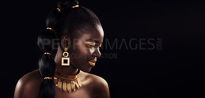 Buy stock photo Studio shot of a beautiful young woman wearing make up and jewellery against a black background