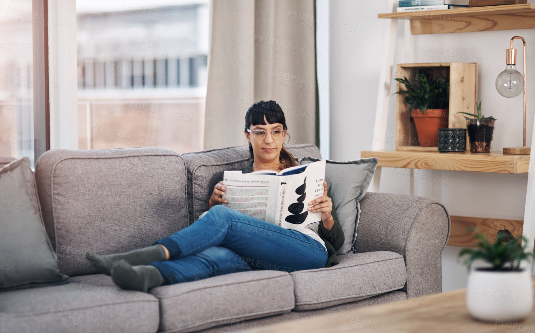 Buy stock photo Relax, reading and woman with novel on sofa in home for calm, peace and self help literature. Weekend, rest and female person in living room with non fiction book for psychology knowledge in house.