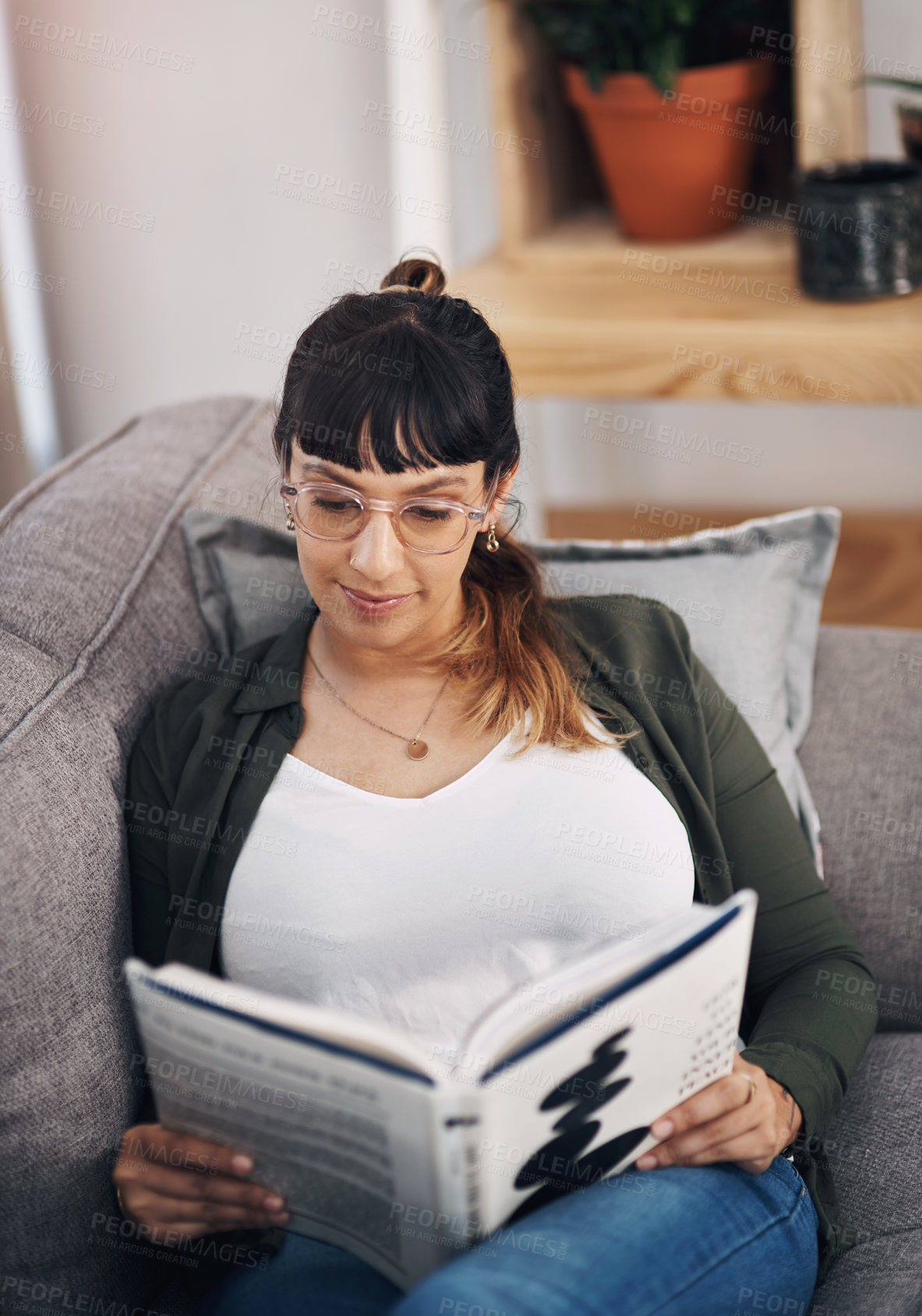 Buy stock photo Relax, reading and woman with book in living room in home with smile for calm, peace and self help literature. Happy, rest and person on sofa with non fiction novel for psychology knowledge in house.