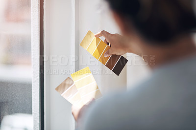Buy stock photo Cropped shot of an unrecognizable businesswoman standing alone in her office and looking at a colour swatch