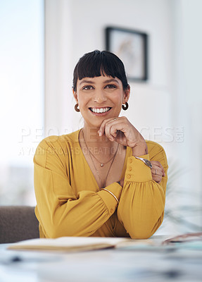 Buy stock photo Cropped portrait of an attractive young businesswoman sitting alone in her office with her hand on her chin
