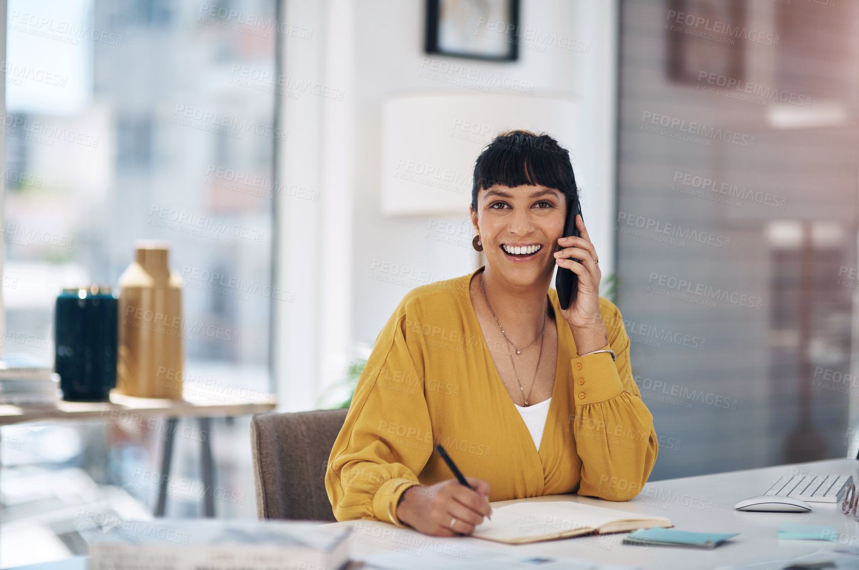 Buy stock photo Cropped portrait of an attractive young businesswoman sitting alone in her office and using her cellphone