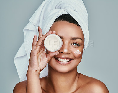 Buy stock photo Cropped shot of a beautiful young woman posing with a pot of moisturizer