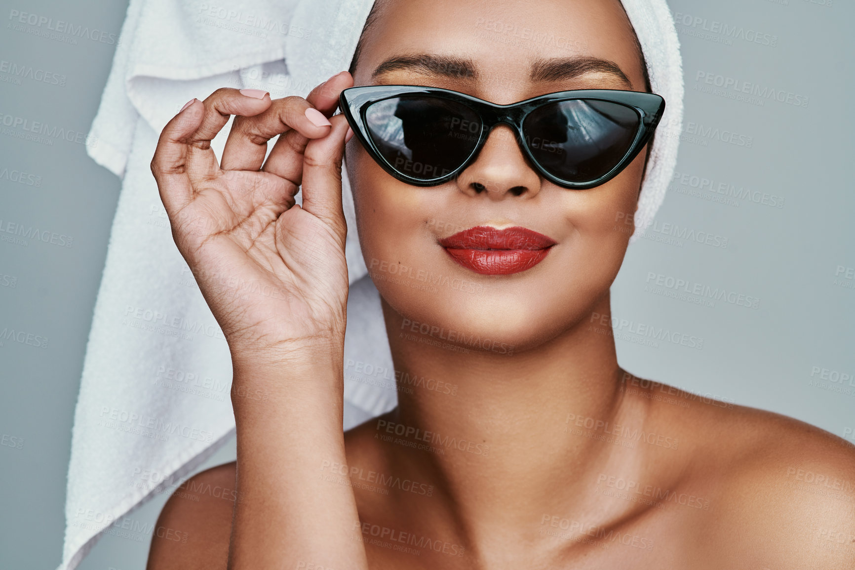 Buy stock photo Cropped shot of a beautiful young woman posing with sunglasses and red lipstick