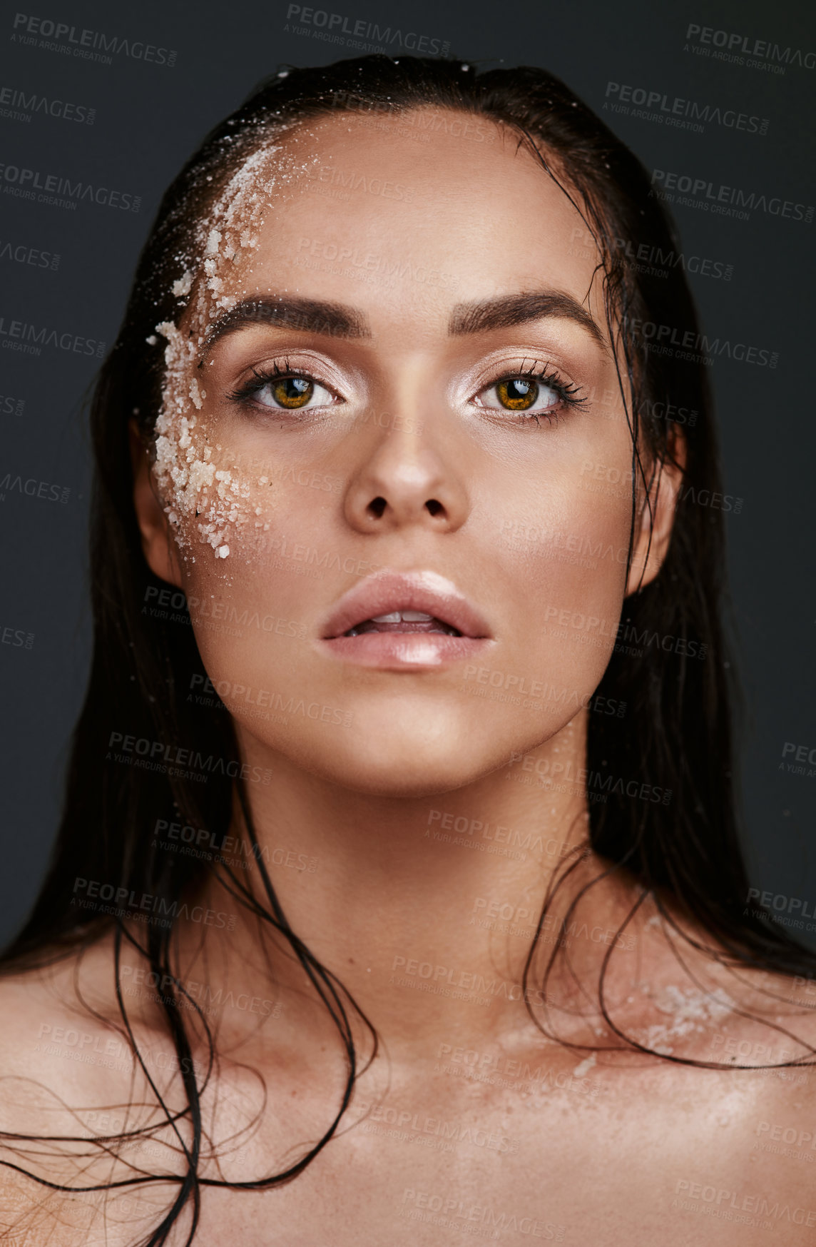 Buy stock photo Shot of a beautiful young woman posing with salt on her face