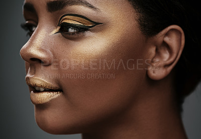 Buy stock photo Profile, makeup and woman with beauty, thinking or gold eyeshadow on face. African model, facial cosmetics and eyeliner for skin glow, aesthetic and creative cat eye on gray studio background closeup