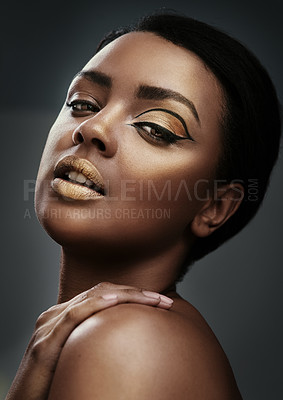 Buy stock photo Cropped shot of a beautiful young woman wearing gold makeup against a grey background