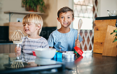 Buy stock photo Shot of two adorable little boys baking together at home