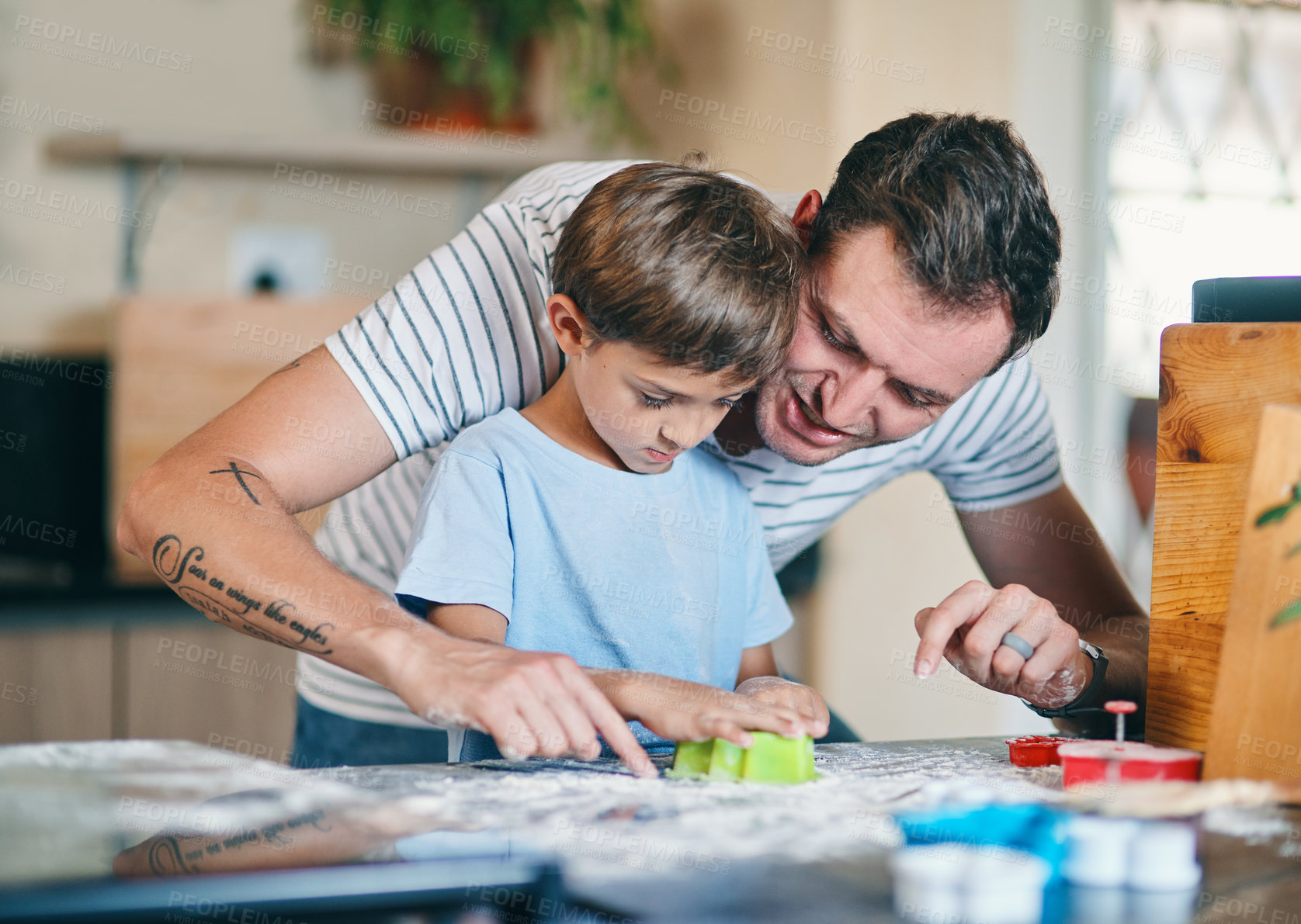 Buy stock photo Shot of an adorable little boy baking with his father at home