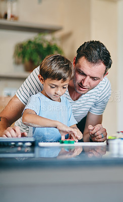 Buy stock photo Shot of an adorable little boy baking with his father at home