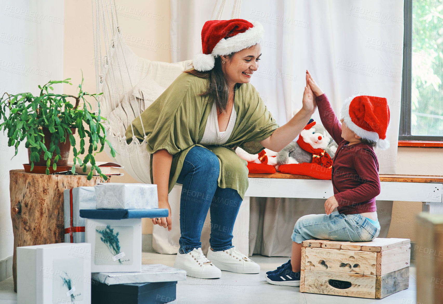 Buy stock photo Woman, boy and high five in house for Christmas holiday, story time and relax with gifts or presents.  Mother, child and bonding together in home for joy with family, smile or festive celebration