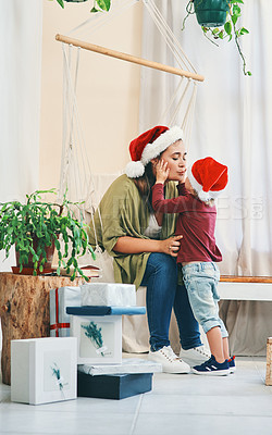 Buy stock photo Shot of a young woman spending quality time with her adorable son at Christmas