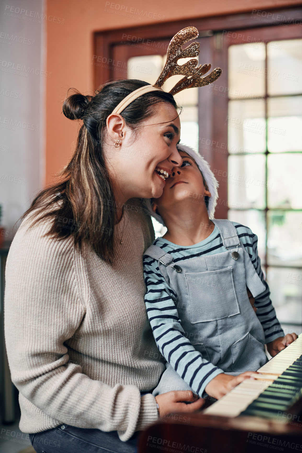 Buy stock photo Mom, boy and piano at Christmas in home for singing, love or learning for music, performance or notes. Mother, child or son by keyboard for teaching, guide and helping for talent development at xmas