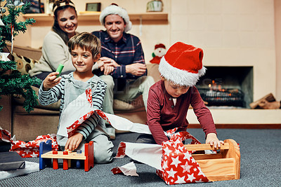 Buy stock photo Christmas, gift and kids on floor with parents, excited and festive celebration together in home. Present, surprise and happy family with holiday fun, smile and winter vacation in living room