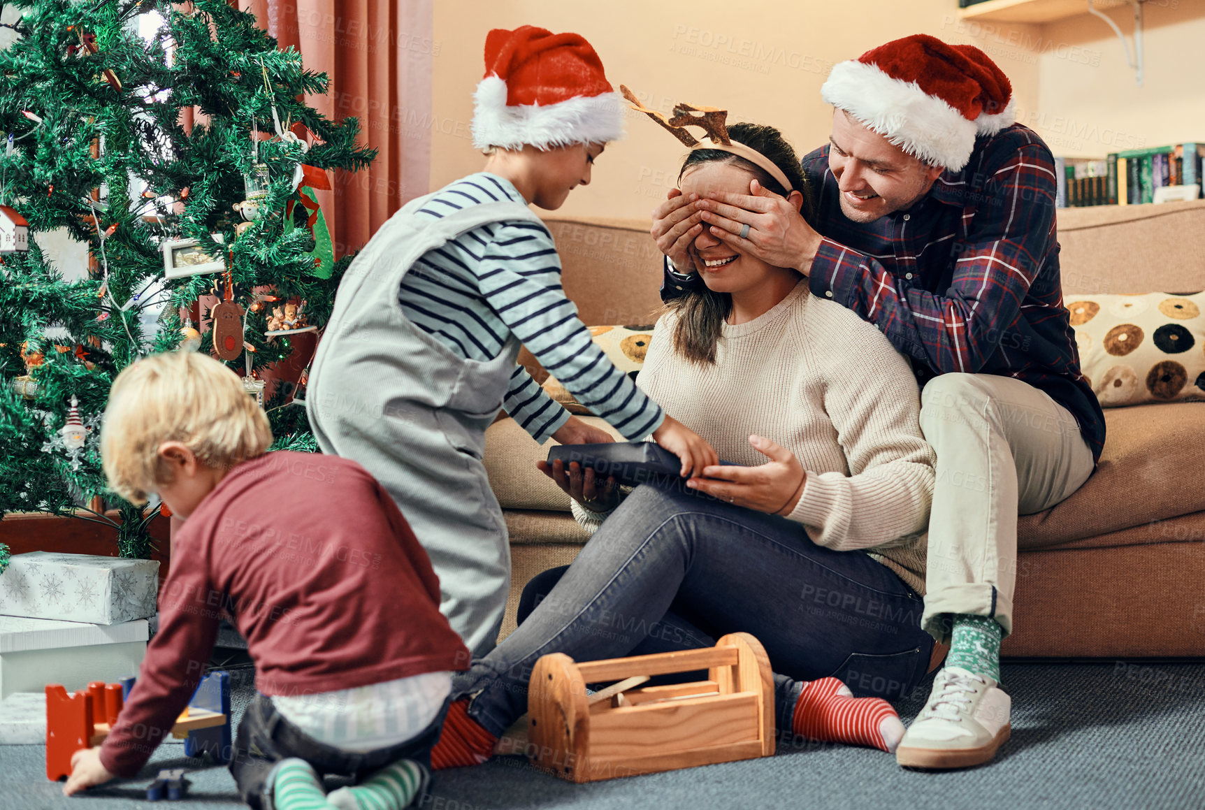 Buy stock photo Family, surprise and mother with gift on Christmas, man and hands covering on mothers eyes. Child, festive present and holiday in winter apartment or bonding together, excitement and love with people