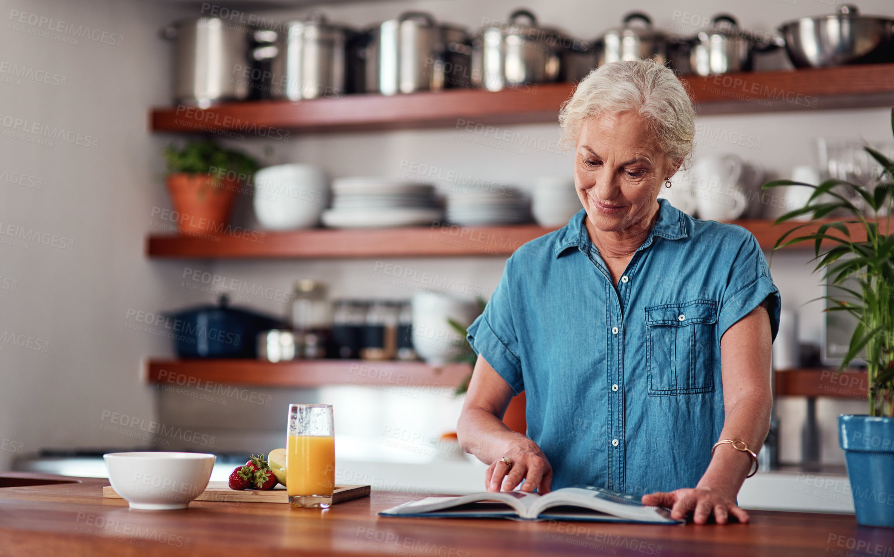 Buy stock photo Mature woman, kitchen and recipe book for cooking, ingredients and read for instructions. Vegan, fruit and diet for health food in home, female person and juice for breakfast meal in retirement 