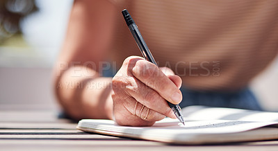 Buy stock photo Hand, writing and book with a woman author sitting outdoor in summer for inspiration as a writer. Idea, planning and notebook with a female person using a pen to write in her journal or diary outside