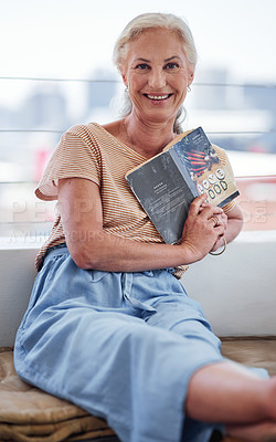 Buy stock photo Cropped portrait of an attractive senior woman reading a book while relaxing on her balcony at home